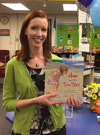 photo of Roberta Roelfs holding her book 
